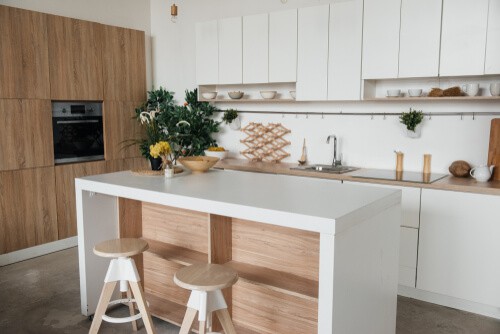 white kitchen with wooden accents and kitchen island with storage